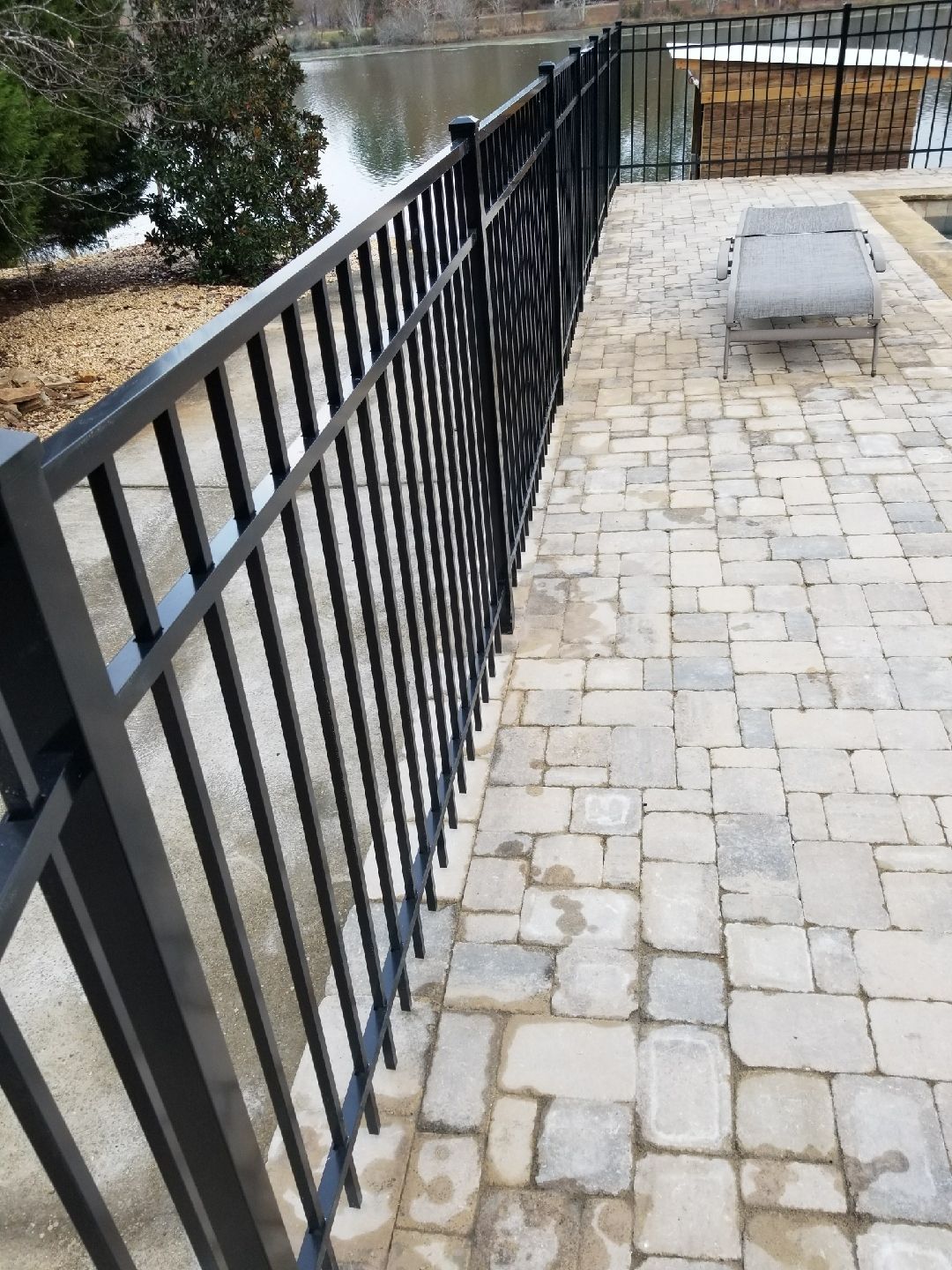 Aluminum Flat Top Corred Into Pool Deck fence installed by Shelby Fence Company in Alabaster, AL