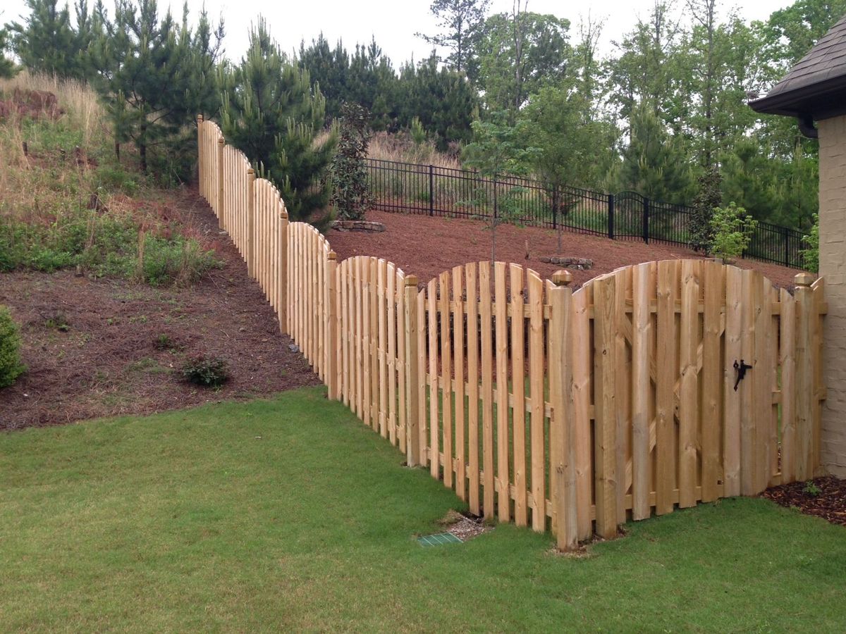 Arched shadowbox wood fence in a residential Alabaster backyard
